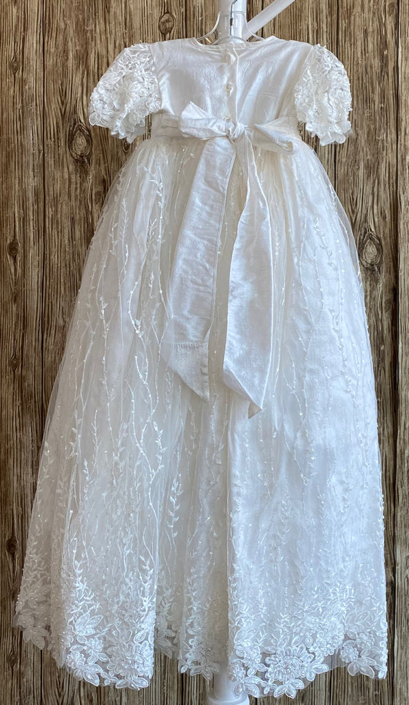 his a beautiful, one-of-a-kind baptism gown.  A lovely gown for a precious child.  White, size 6M  Textured satin bodice Knitted lace sleeves Intricate rhinestone belt Beaded tulle overlay on satin skirting 