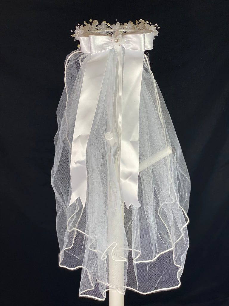 White Veil - Flower Halo Crown with pearls and rhinestones and bow.  Elegant soft 2 layer tulle veil with delicate hand stitched braided satin trim around the edge and handmade flower halo crown with veil with large white satin bow on back. Beautiful organza flowers along crown, with pearl and rhinestone centers. Stunning rhinestone leaves around flowers.  This double layered veil reaches approximately 24" long, with a crown diameter of 6". Veil has 2" long, 3" wide, comb to secure it in place. 