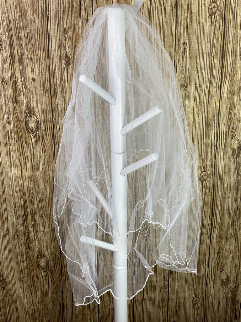 White - Classic Veil for First Communion   Elegant soft 2 layer tulle veil with delicate hand stitched white pencil trim.   Veil length - 31 in. long, comb - 7 cm wide  Materials:  sturdy plastic comb and soft tulle.