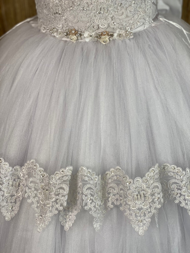White, size 12 Squared neck Lace embroidered bodice Pearl, rhinestone, and rose thin band along bottom of bodice Layered tulle skirt with embroidered trim on top layer Button closure Big satin bow on back