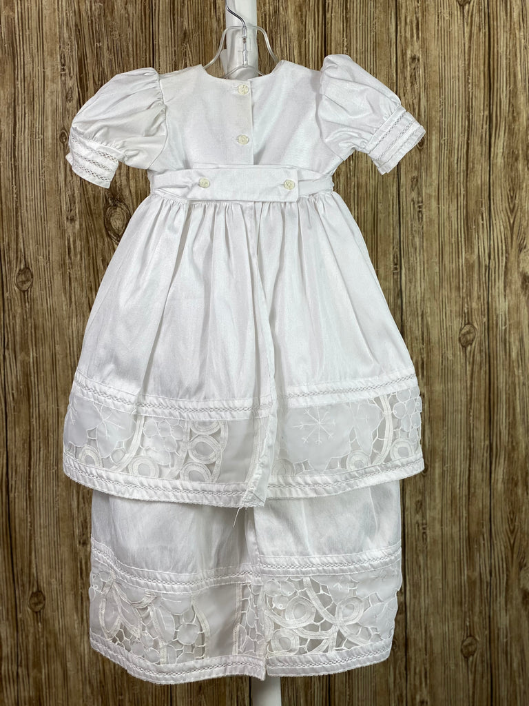 This a beautiful, one-of-a-kind baptism gown.  A lovely gown for a precious child.  White, size 12M Two layered dress Satin bodice with lace detailing Puffed satin sleeves with lace trim Satin skirting with thick lace detailing Satin second layer with thick lace detailing Button closure in the back Lace bonnet with satin ruffled brim