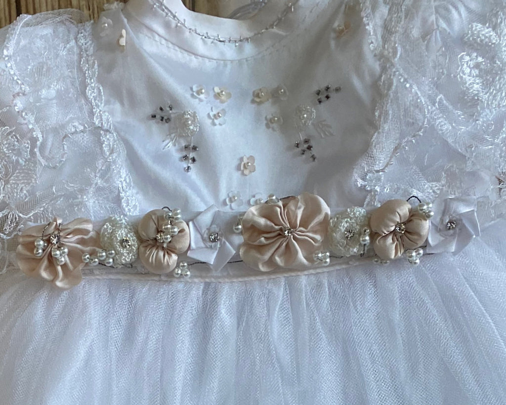 This a beautiful, one-of-a-kind baptism gown.  A lovely gown for a precious child.  White, size 12M Cropped satin bodice with embroidered flowers Hand stitched neckband Satin champagne flowers from goddess edge Lace sleeve Layered skirting  Satin champagne flower edging along top layer of skirt Embroidered lace tulle on second layer Beaded floral detailing on tulle on third layer Final layer is tulle