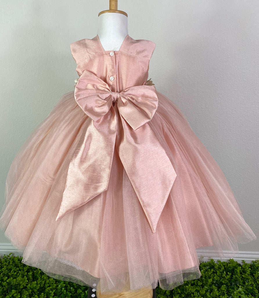 BLUSH  Blush squared neck bodice Ivory and beige flower with pearl center cummerbund Blush ruched tulle and satin skirting Button closure Large blush bow on back Dress pictured with a petticoat Petticoat not included  Choose from a tulle, cloth, or wire for best look