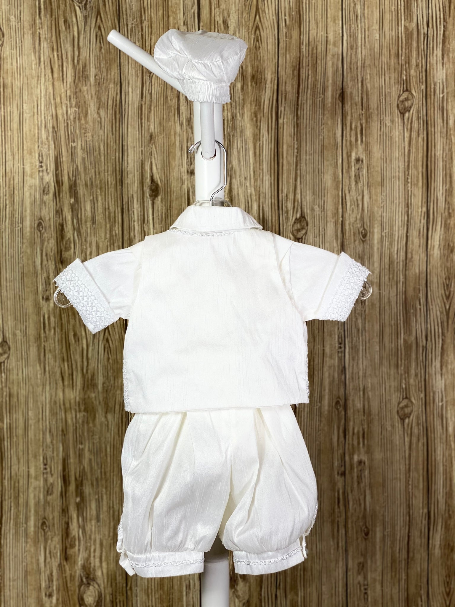 This a beautiful, one-of-a-kind boy’s baptism gown/set.  Lovely clothes for a precious child.  White, size 6M  5-piece set including shirt, pants, vest, bow tie and beret Pearl closure on vest Braided trim on vest collar edging, pant cuffs and cummerbund, and beret band Pearl button down shirt with crochet ribbon down sides Ribbon around arm cuffs and pant legs Buttoning on pant cuffs Elastic banding behind pants