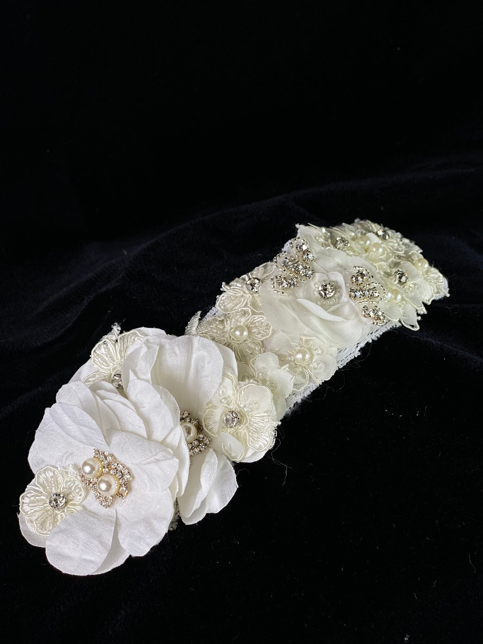 aptism Headwrap - White Flower with Ivory Band & Pearls & RhinestonesThis is an elegant handmade and one-of-a-kind headwrap with a large White flowers and Ivory band.  The large flowers are uniquely decorated with rhinestones and pearls.  The elastic headwrap is made of a soft ivory satin with an intricate and original design made up of flowers and jewels.  This headwrap can be worn with dresses from Stelalysa's Baptism & Celebration/Pageant Collections and for any occasion!  It fits best on girls ages 1-6.