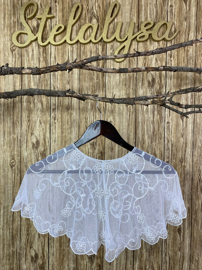 Gorgeous tulle shawl with embroidered flower detailing throughout body, showcasing beautiful pearls in the center.  This shawl can be worn with either a white or ivory communion dress/gown from our collection.  She will look like a princess wearing this elegant shawl on her special day!  