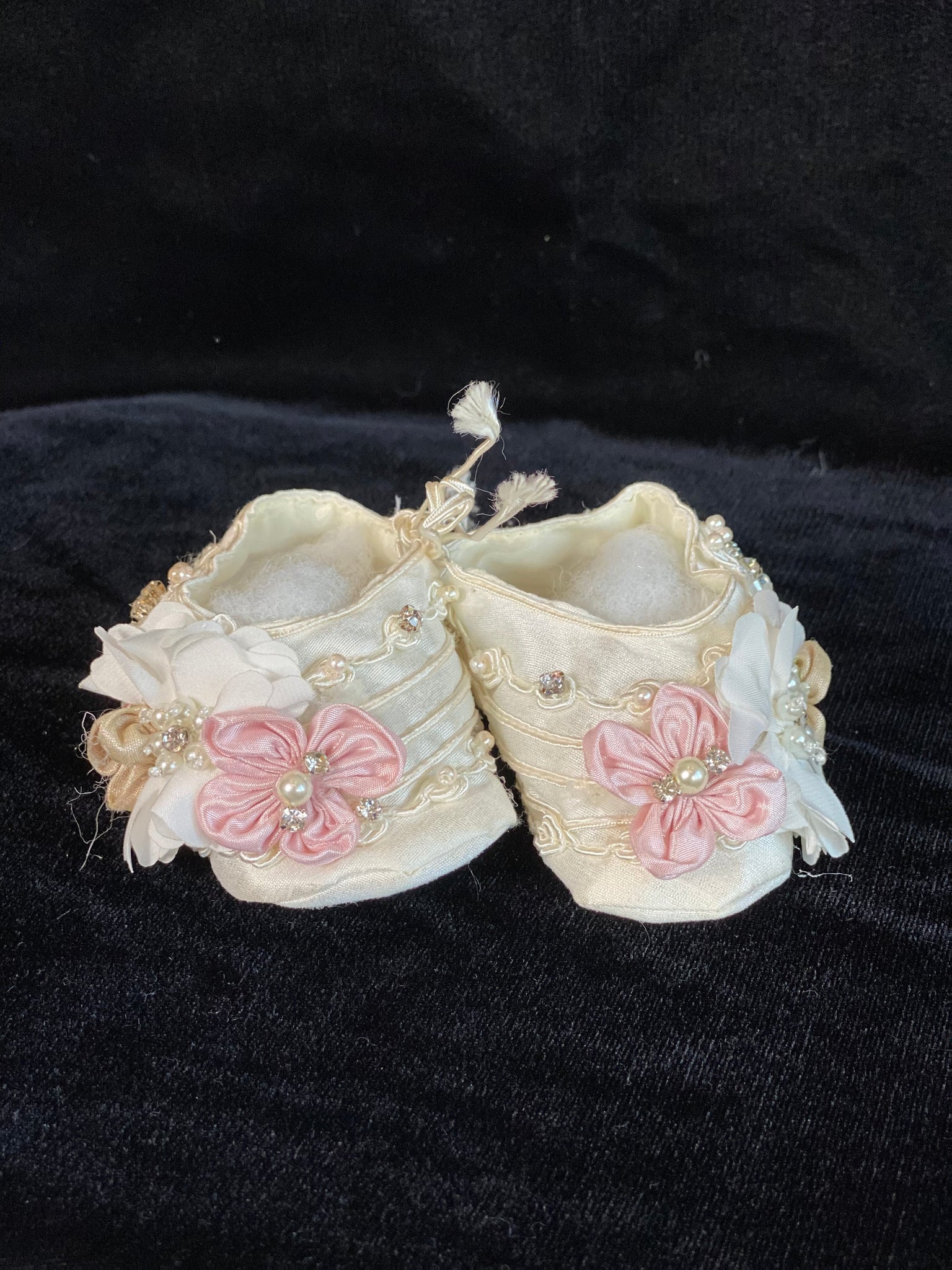 Elegant handmade ivory baby girl ankle boots with embroidery, lace, flowers, and jewels (pearls and crystals) with side string closure.