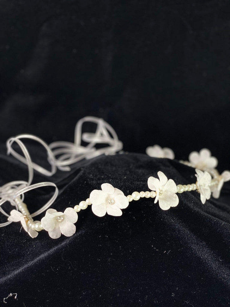 A must have for the First Communion!   Beautiful headband applique with pearl banding. Organza flowers with rhinestone centers placed spaciously on band. Elegant satin ribbon to tie on to head.   Headband is 20" long, to tie beautifully around the head.  This headband will adorn a Stelalysa veil!  Wear with either a white or ivory First Communion dress!