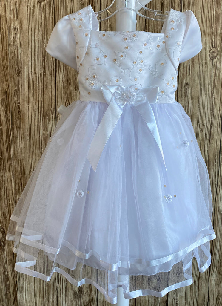 This a beautiful, one-of-a-kind baptism gown.  A lovely gown for a precious child.  White, size 12M Satin bodice with gold (sequins) and white embroidered flowers White cap sleeve  Large bow with floral center on bodice edge Tulle skirting with white roses Ribbon edge around tulle skirt Large ribbon bow in back 