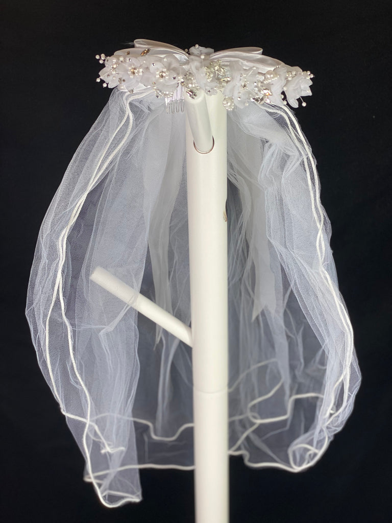 Elegant soft 2 layer tulle veil with delicate hand stitched braided satin trim around the edge and handmade flower halo crown with veil with large white satin bow on back. Organza flowers with sparkling rhinestone and pearl centers. Beautiful pearl leaves sticking out around flowers.  This double layered veil reaches approximately 24" long, with a crown diameter of 6". Veil has 2" long, 3" wide, comb to secure it in place. 