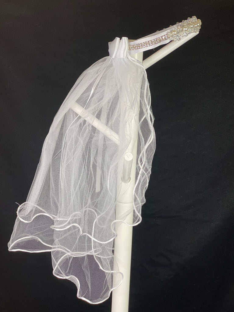 Elegant soft 2 layer tulle veil with delicate hand stitched braided satin trim around the edge and handmade flower halo crown with veil with large white satin bow on back. Ivory pearl and clear crystal cluster along front of crown. Gorgeous rhinestone band around sides and back of crown.  This double layered veil reaches approximately 24" long, with a crown diameter of 6". Veil has 2" long, 3" wide, comb to secure it in place. 