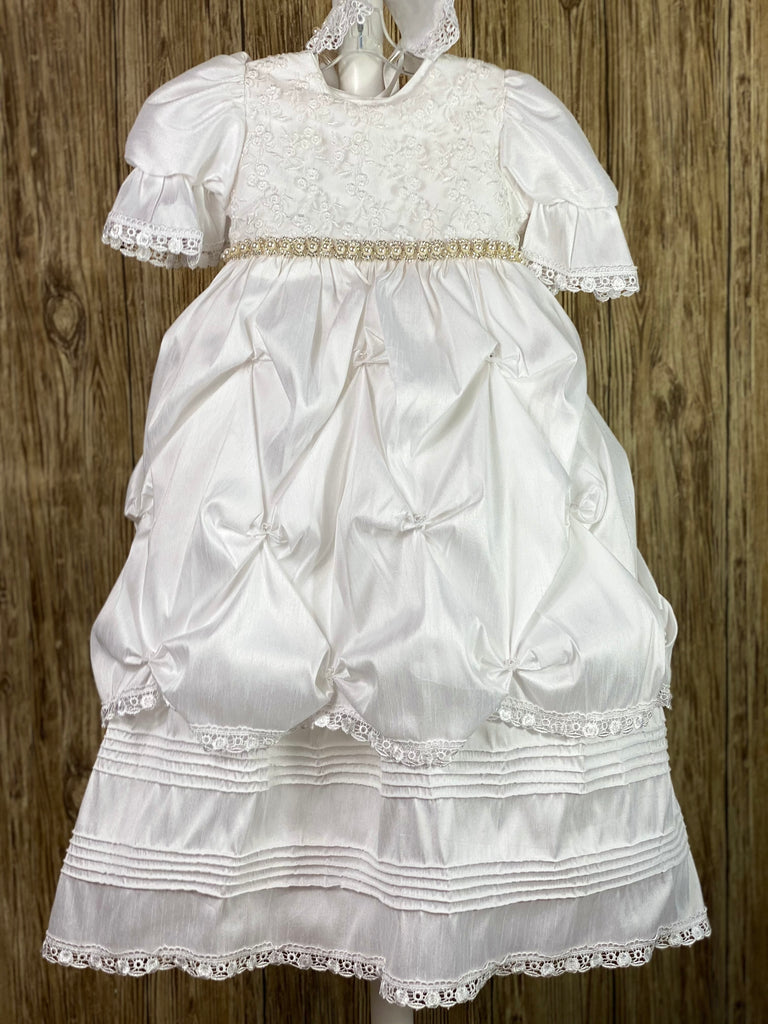 his a beautiful, one-of-a-kind baptism gown.  A lovely gown for a precious child.  White, size 24M Two layer dress Satin bodice with gorgeous lace overlay Rhinestone belting Puffed satin sleeves with lace trim Gathered ruffled skirting with rhinestones Second layer has horizonal pinstripes with lace trim  Satin bow in back Satin bonnet  Floral lace brim on bonnet