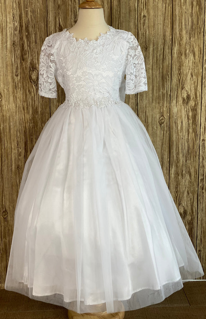 Fall in love with this First Holy Communion dress.  She will feel and look like a princess on her special event.   Lace quarter sleeve Scoop neck with floral trim Lace over satin bodice Floral belt Tulle over satin skirt Tulle ribbon for bow Zipper closure
