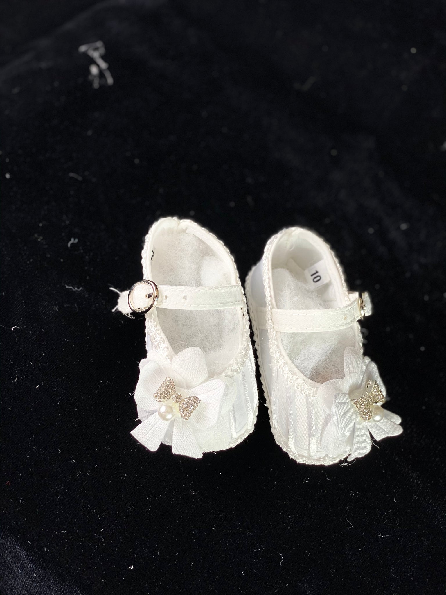 Elegant handmade white baby girl shoes with embroidery, lace, bows, and jewels (pearls and crystals).