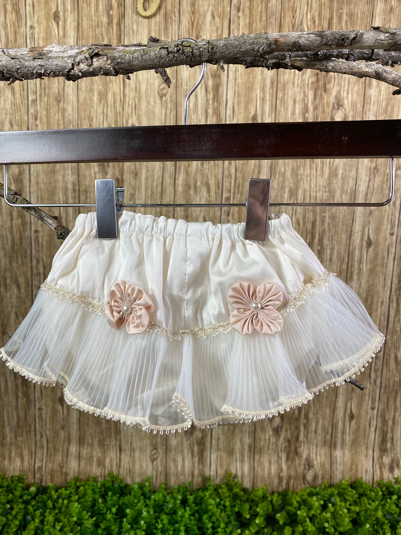 Bloomers with Embroidered Tulle - Ivory  These ivory bloomers are exclusive to Stelalysa!  They are handmade and one of a kind.  The ruffle design in the backside is made of tulle.  Two cute pink satin flowers with a pearl each sit on each side with embroidered lace trim making it a gorgeous piece.   One size fits 3 to 12 month old babies.     These bloomers are perfect to put under any of our Baptism dresses. . 