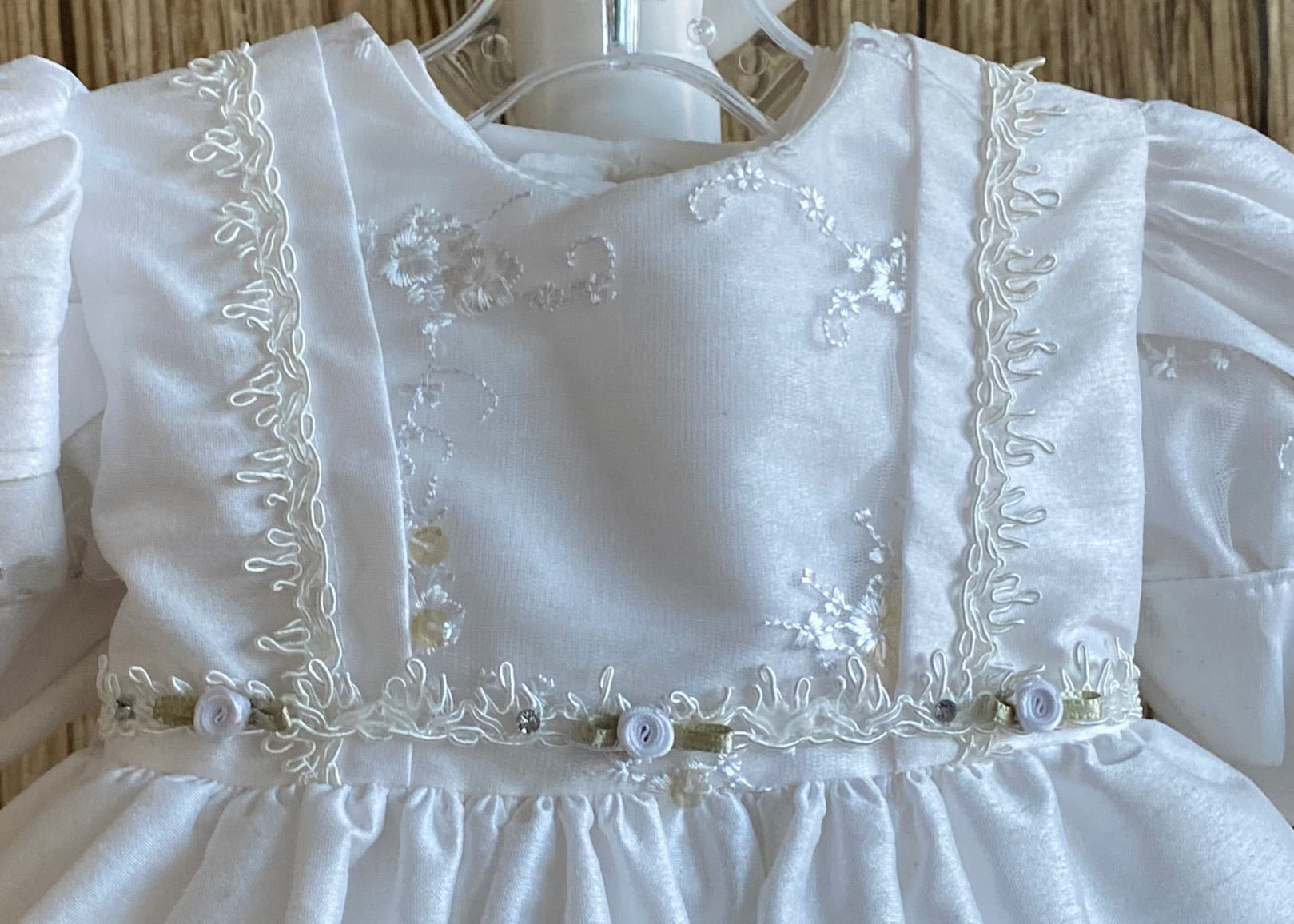 This a beautiful, one-of-a-kind baptism gown.  A lovely gown for a precious child.  White, size 6M Satin bodice  Embroidered beaded lace detail on bodice and sleeve Embroidered ribboning on bodice Roses placed along bodice edge Gorgeous puffed satin sleeve  Layered skirting  Pleated Lining on bottom for both skirt layers Embroidered beaded lace on edge of both skirt layers  Beautiful matching satin bonnet with lace detailing on brim  Ribbon to tie on bonnet