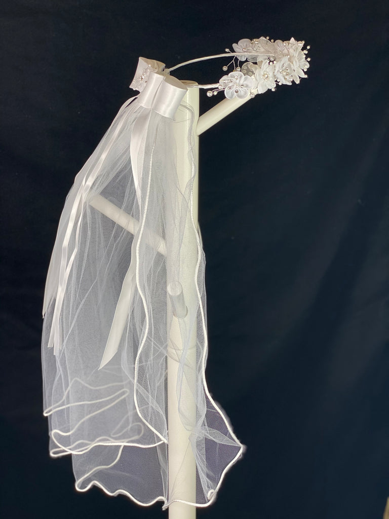 Elegant soft 2 layer tulle veil with delicate hand stitched braided satin trim around the edge and handmade flower halo crown with veil with large white satin bow on back. Stain flowers with sparkling rhinestone petals and centers. Crystal flowers between organza flowers. Beautiful lace leaves sticking out around flowers.  This double layered veil reaches approximately 24" long, with a crown diameter of 6". Veil has 2" long, 3" wide, comb to secure it in place. 