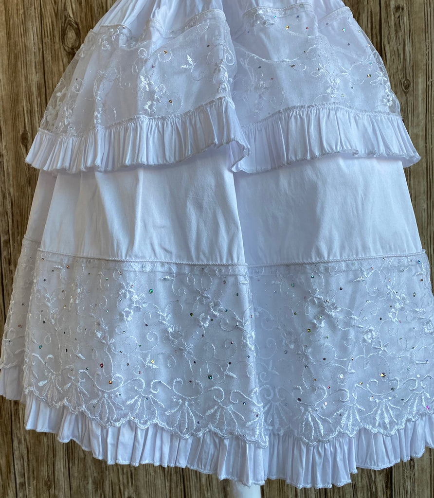 This a beautiful, one-of-a-kind baptism gown.  A lovely gown for a precious child.  White, size 12M Satin bodice Embroidered, bedazzled detailing on bodice Satin ruffle going through bodice Satin puff sleeve with ruffle detailing Organza flowers with rhinestone centers Rhine Stone belt going along bodice edge Layered satin skirting with embroidered, bedazzled detailing Ruffles edging skirt layers